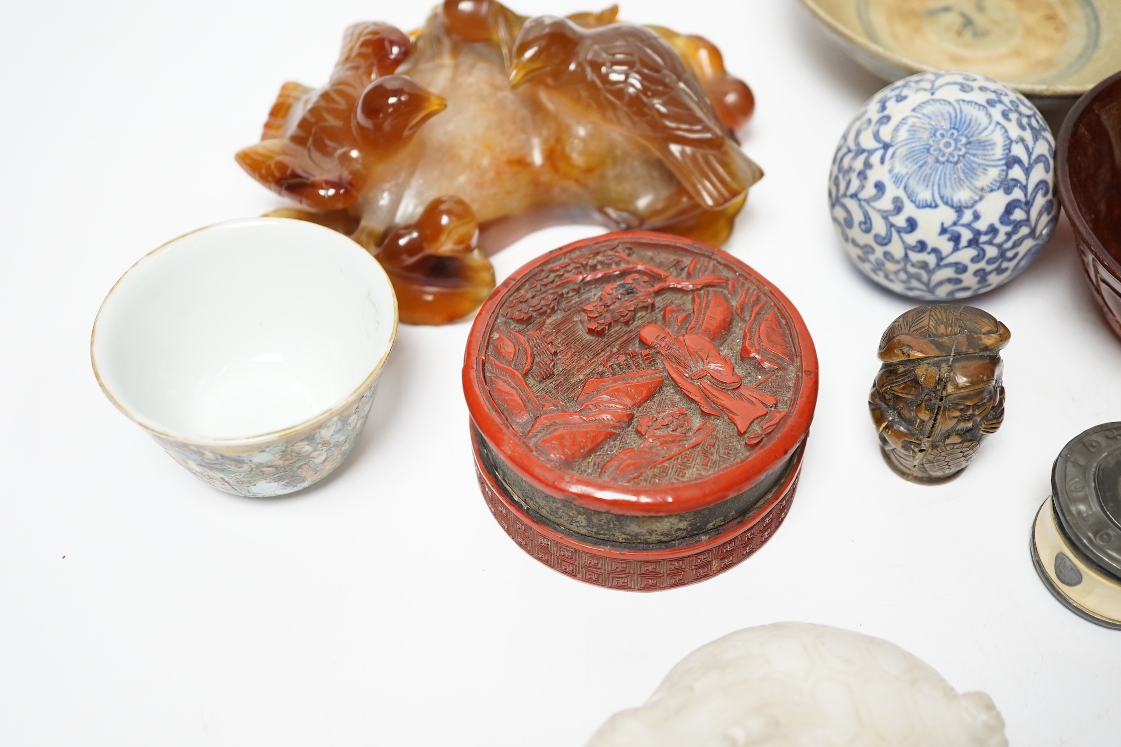 Eleven Chinese or Japanese items including; a bowl, a red lacquer box, an agate carving of a bird group, a carved hardstone lion tortoise, mother of pearl counters, etc.